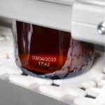laser coding on glass bottle by Markem-Imaje
